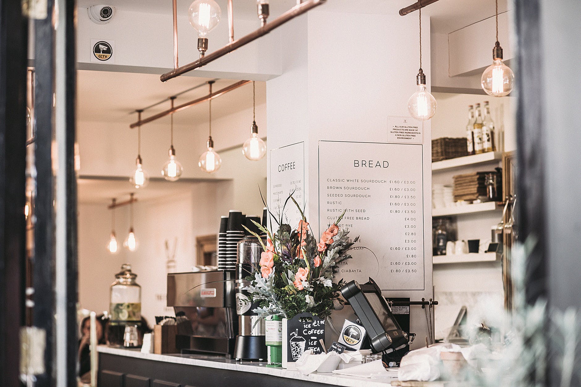 inside the restaurant with pendant lamps and flowers