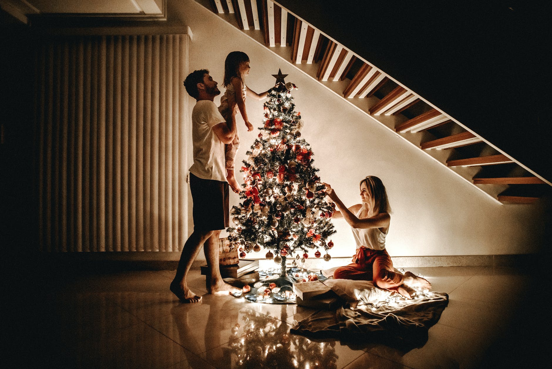 family decorating their christmas tree