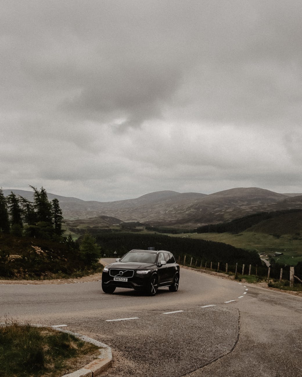 black suv driving on an uphill road