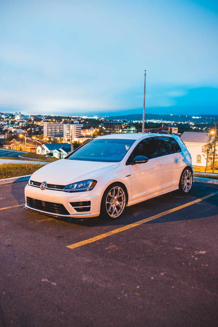 simple white car on parking in dusky city