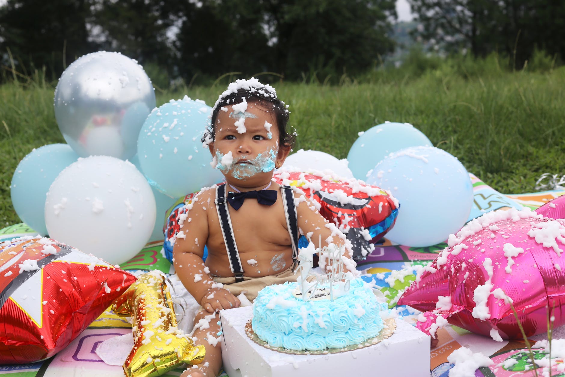 a little boy with his birthday cake smeared on him