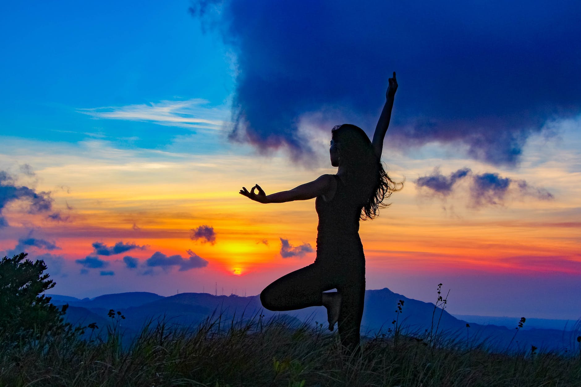 woman in yoga pose in mountains